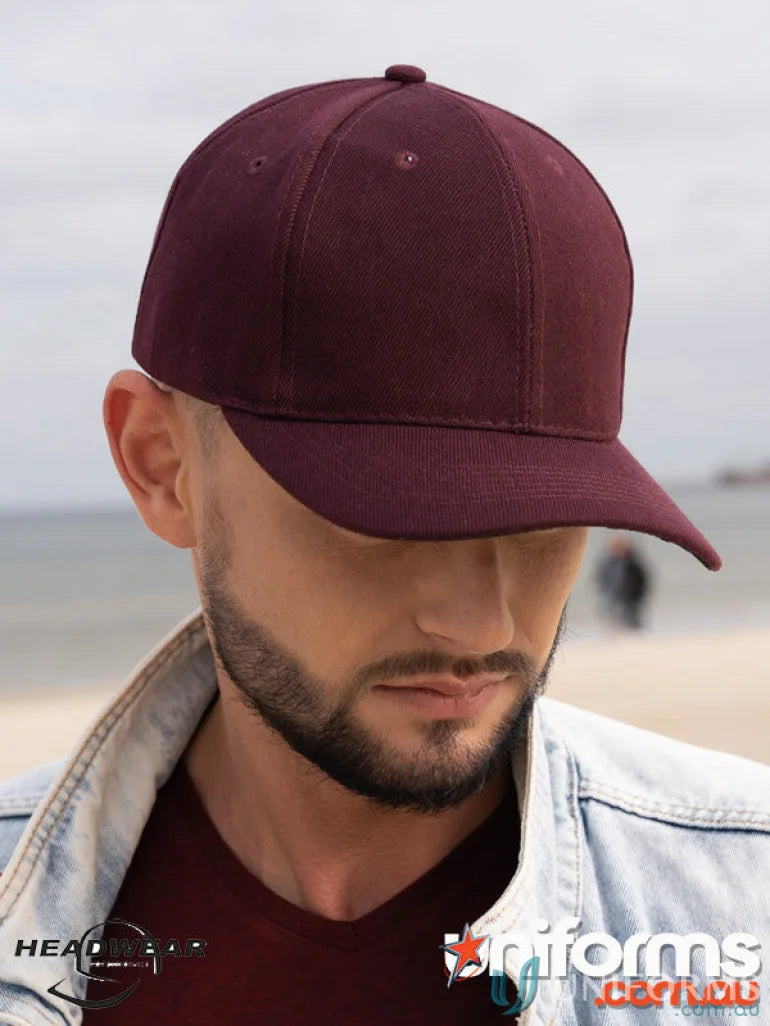 Maroon baseball cap on a person’s head, perfect for uniforms or workwear, see faq link