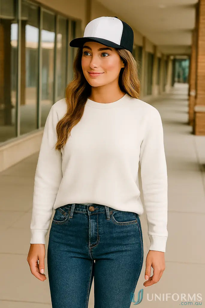 Woman in off-white shirt and jeans with black white baseball cap and pro sticker