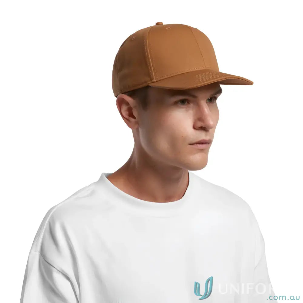 Man wearing a plain brown Premium AS Colour stock canvas cap with tonal under-peak lining