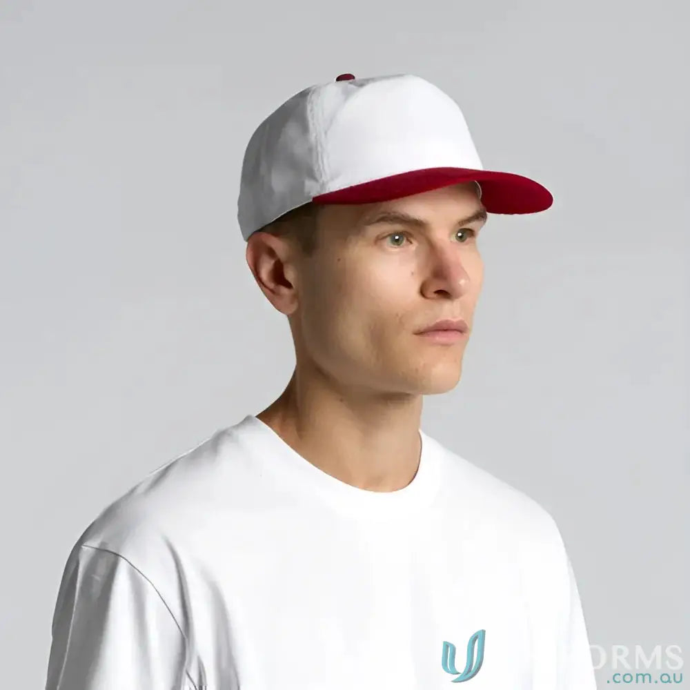 White cotton 16-wale partridge cord cap with red brim worn by a man in a white t-shirt