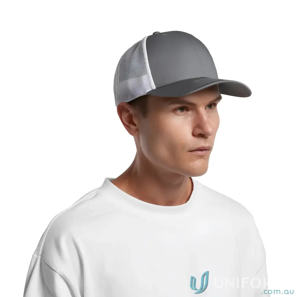 Man wearing a white t-shirt and grey white mesh trucker cap with curved peak