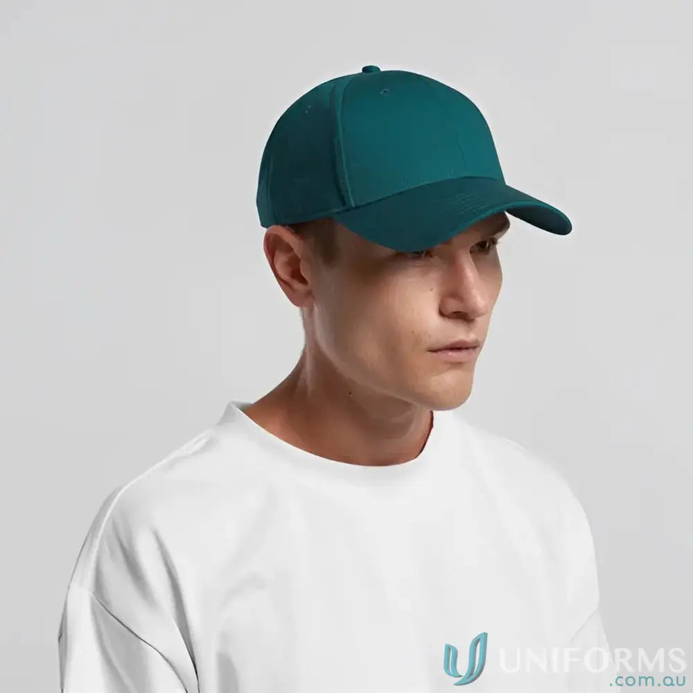 Man wearing a teal snapback cap with curved peak and tonal under-peak lining
