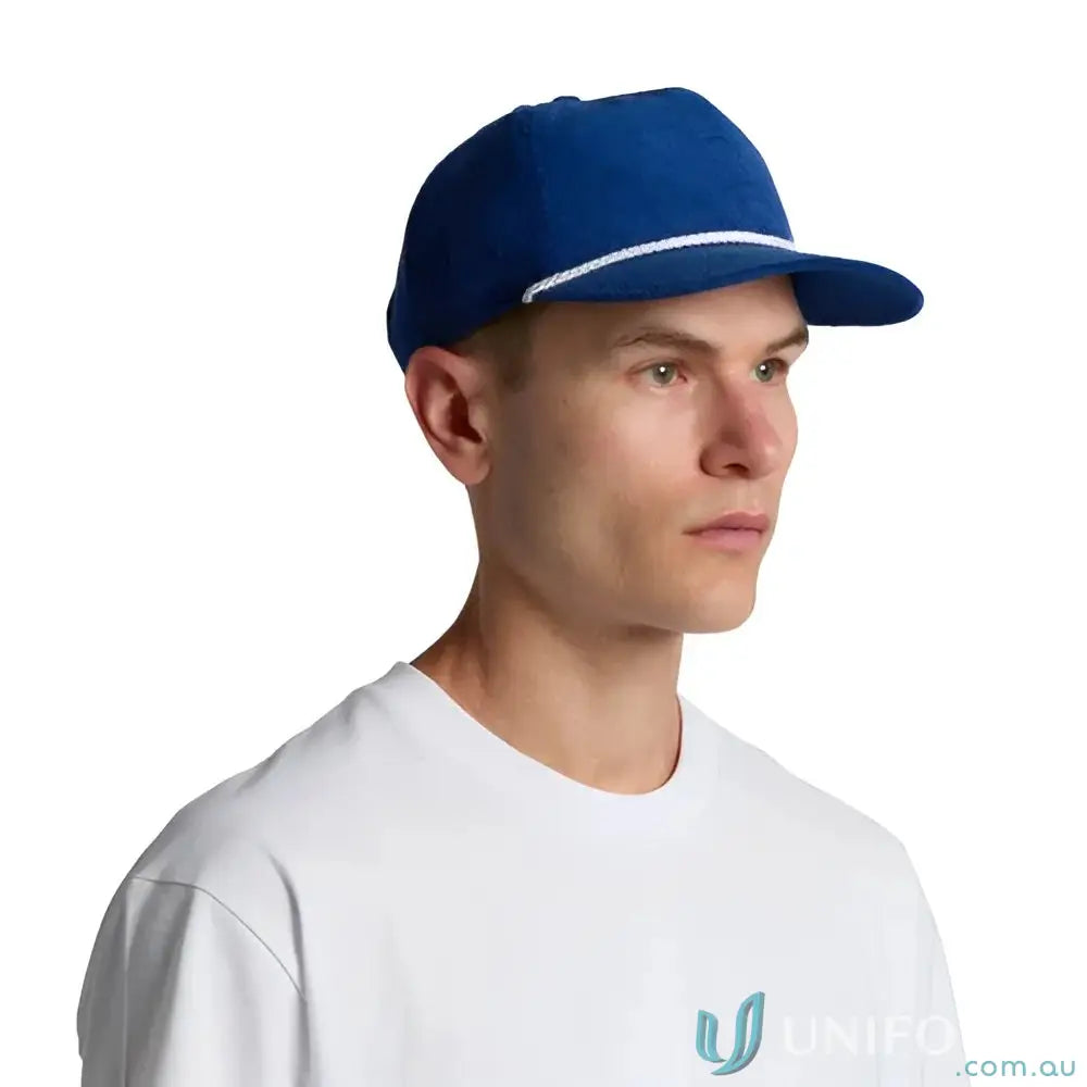 Man wearing royal blue unstructured five-panel cap with 16-wale partridge cord and matte nylon rope