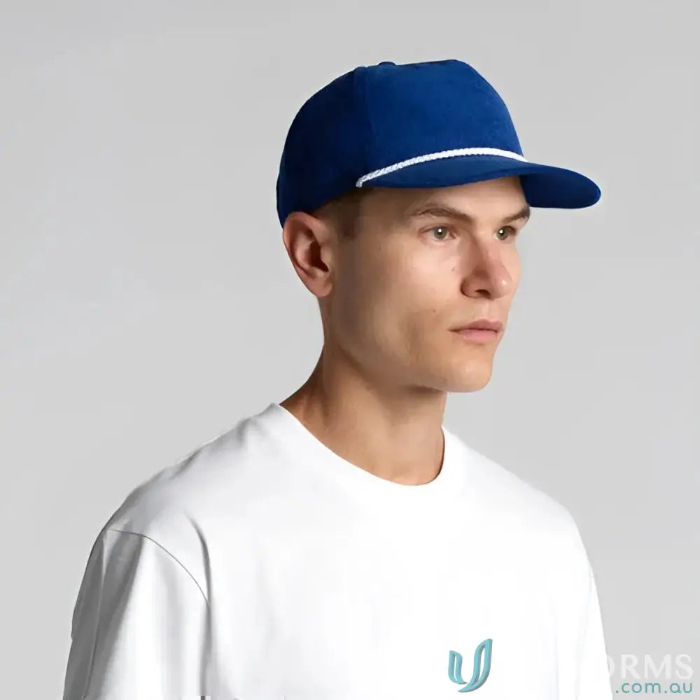 Man wearing royal blue unstructured five-panel cap with white cord and matte nylon rope