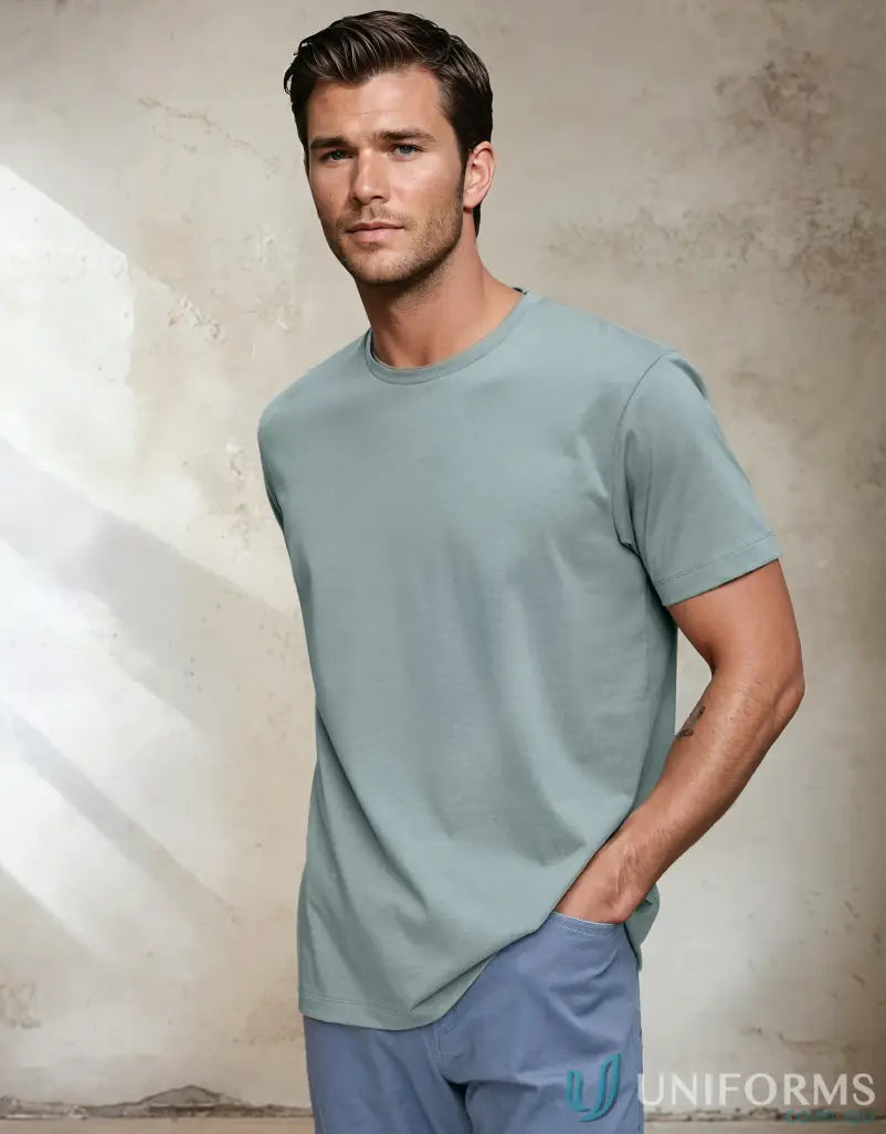 Man in a light green Winning Spirit Premium T-Shirt made from cotton face tee