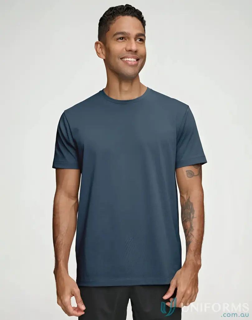 Man in a blue Winning Spirit Premium Cotton Face Tee for a casual look