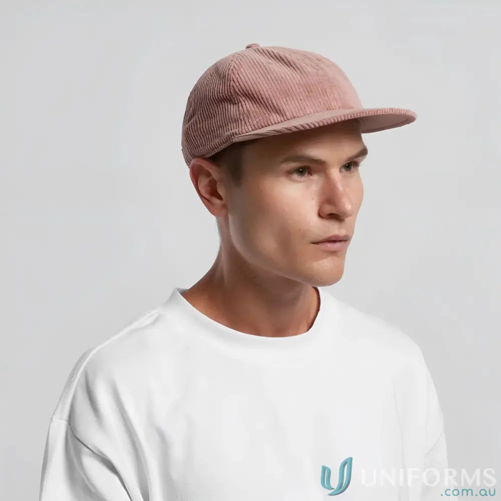 Man wearing a pink unstructured six-panel cap with 8-wale partridge cord and adjustable metal clasp