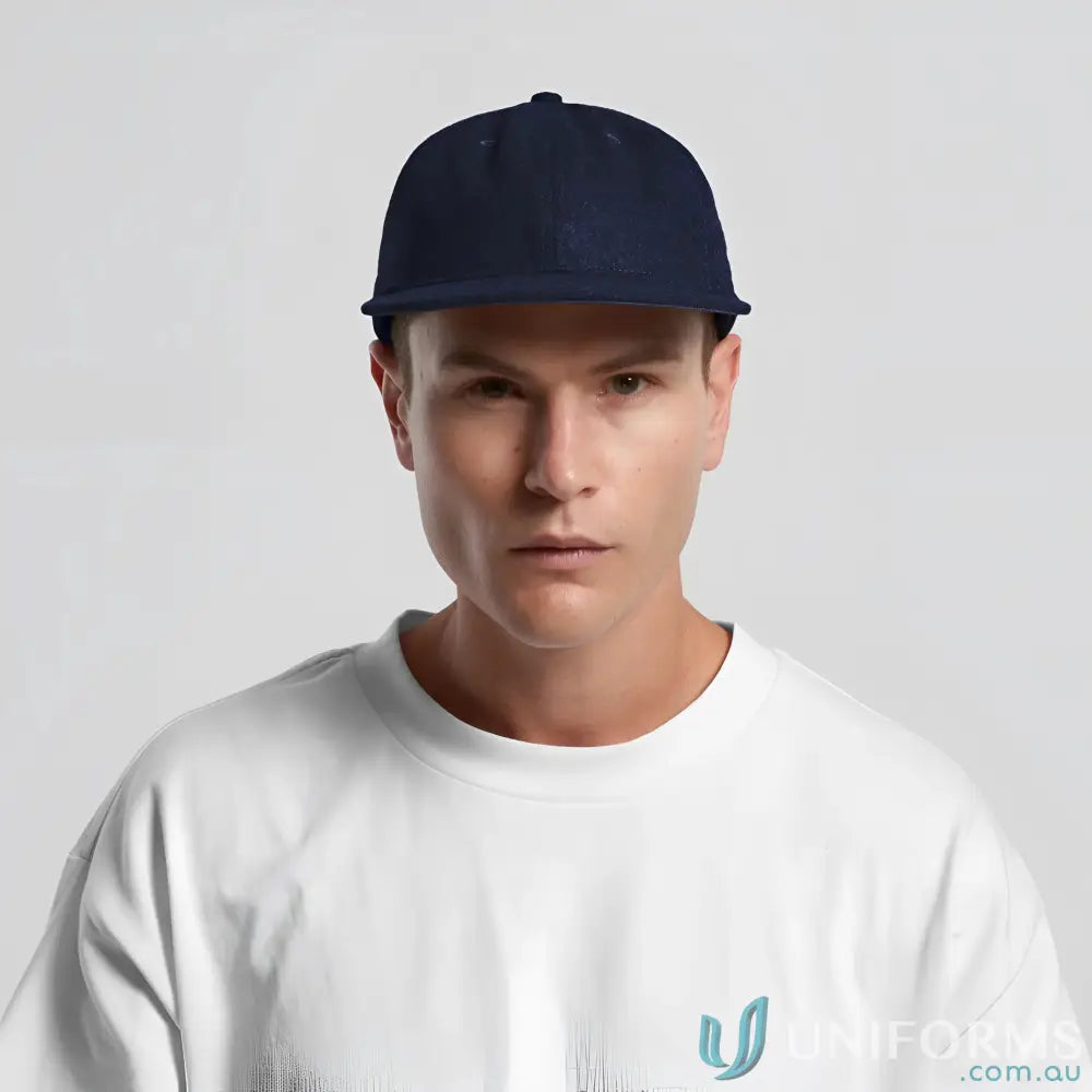 Man in navy blue flat-brimmed cap with adjustable metal clasp and tonal under-peak lining