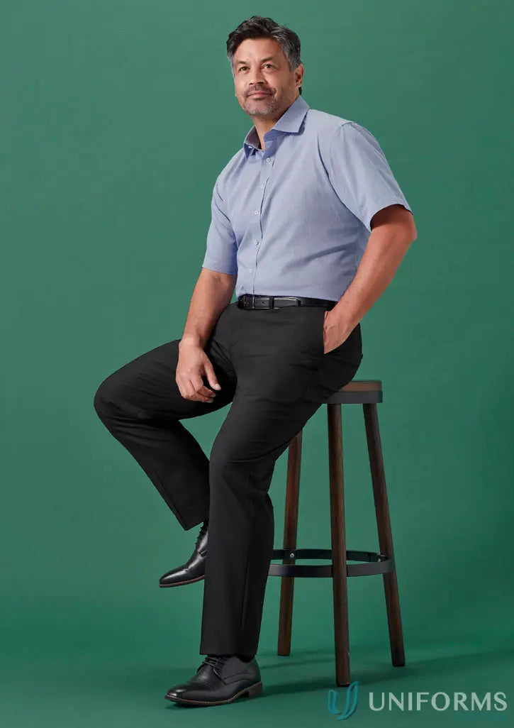 Man in blue shirt sitting on stool wearing Renew Adjustable Waist Straight Leg Pant