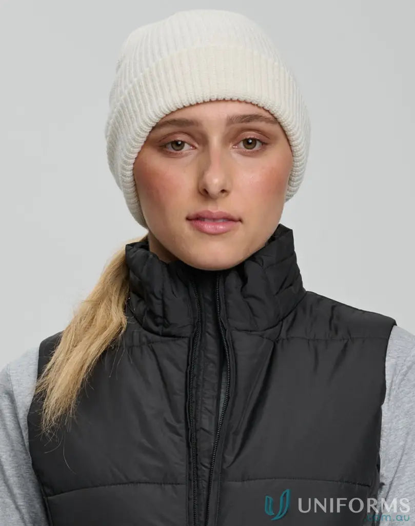 Woman wearing White Beanie with cable knit pattern and knit snug beanie style
