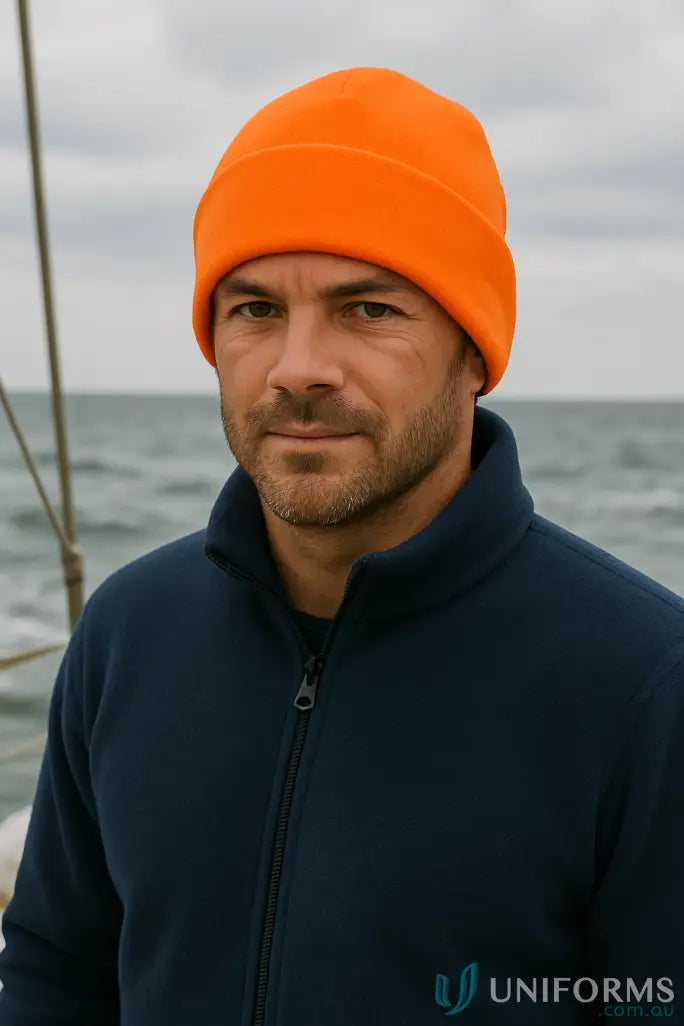 Man wearing orange spirit safety polar polarfleece beanie and dark blue fleece jacket