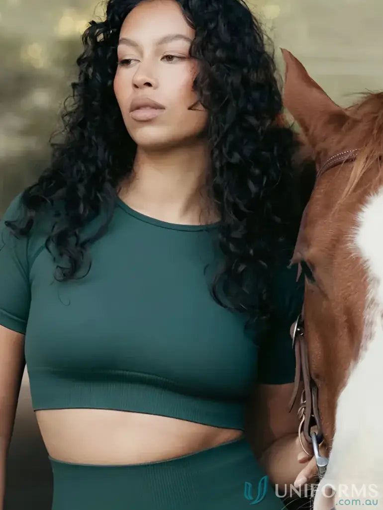 Woman in green Seamless Cropped Emerald Tee with round neck, perfect for uniforms