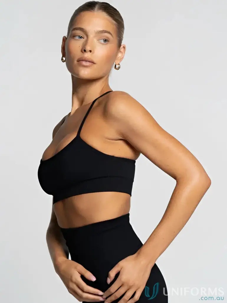 Black athletic bra and high-waisted leggings with flattering scoop neckline for active wear
