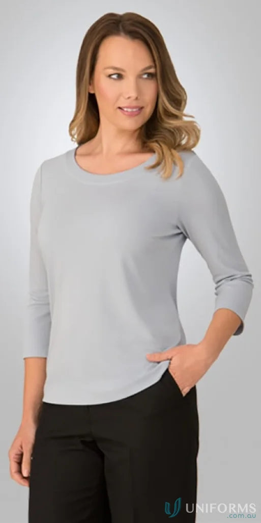 Woman in gray Smartknit top and black pants, perfect stretch workwear uniform
