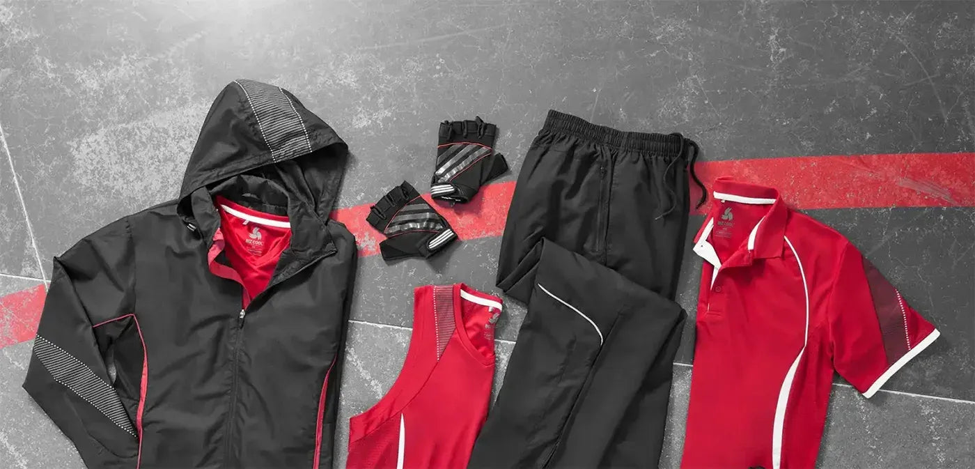 Red and black outdoor clothing set on a gray surface