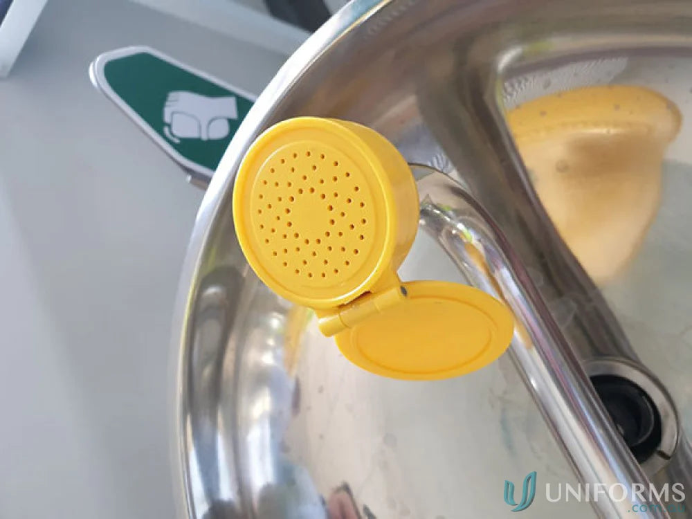 Yellow eye wash station on stainless steel wall mount for uniforms and safety
