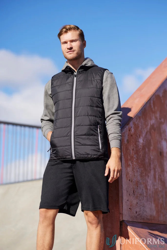 Man in black Stealth Vest featuring core warm PolyFil insulation, part of collection men’s stealth