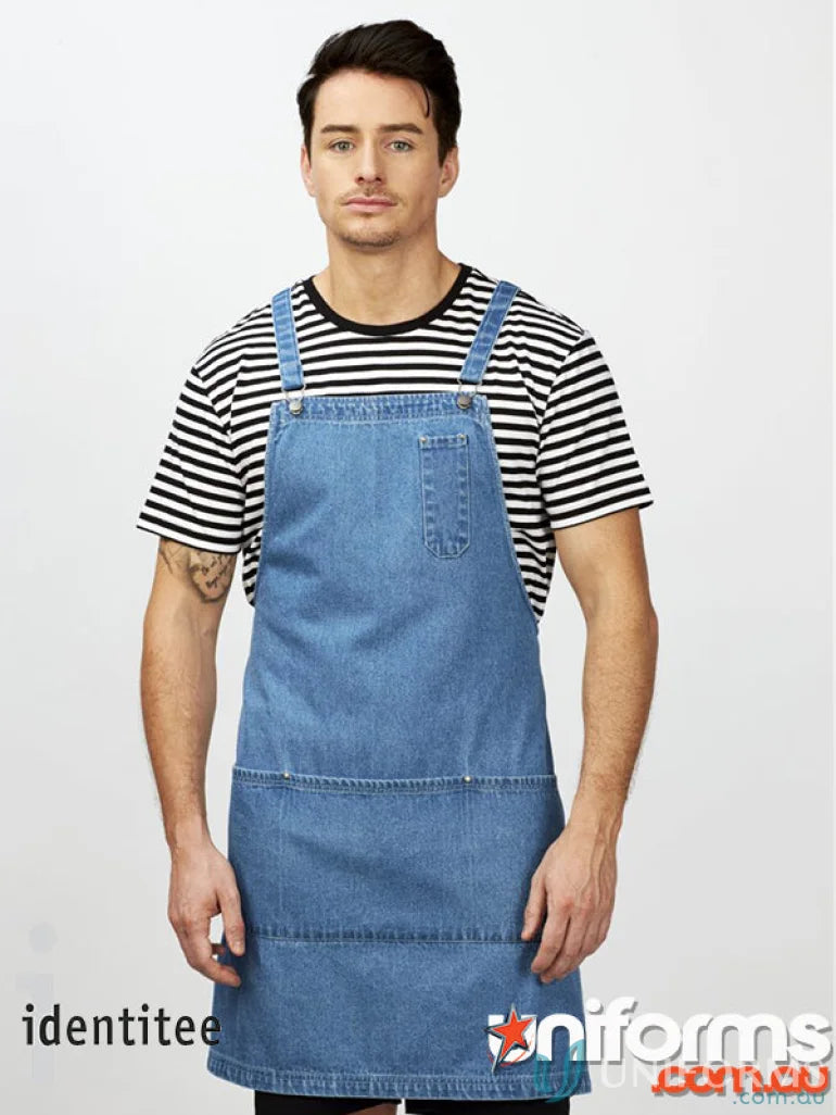 Man wearing light-wash denim apron with pockets over Stevie Stripe T-Shirt in workwear style