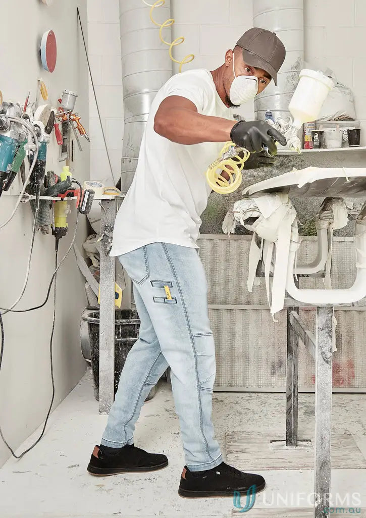 Man spray painting in streetworx stretch jean for demand performance style