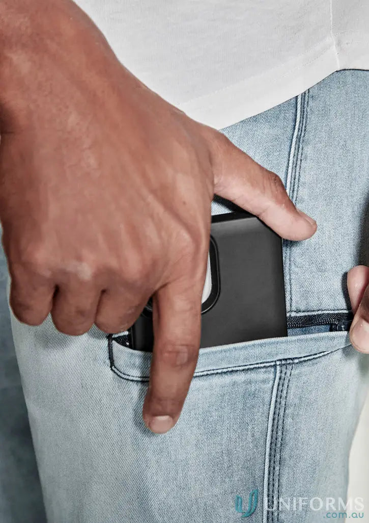 Person putting phone in pocket of Streetworx Stretch Jean, perfect for demand performance