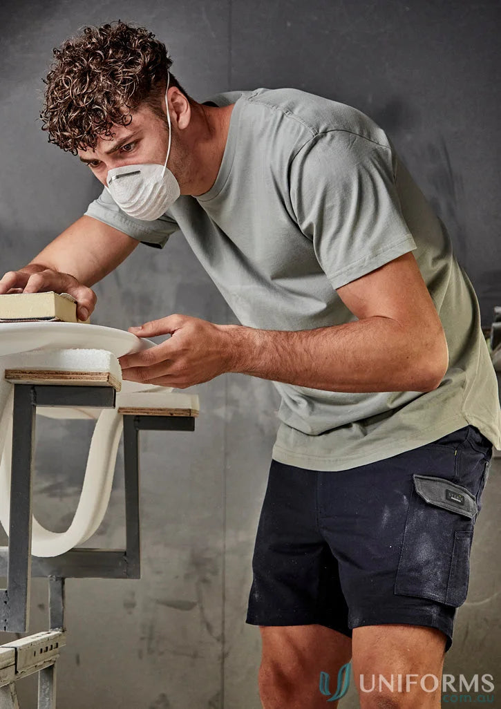 Man sanding a white object in a Streetworx Tee Shirt, breathable cotton slim fit tee