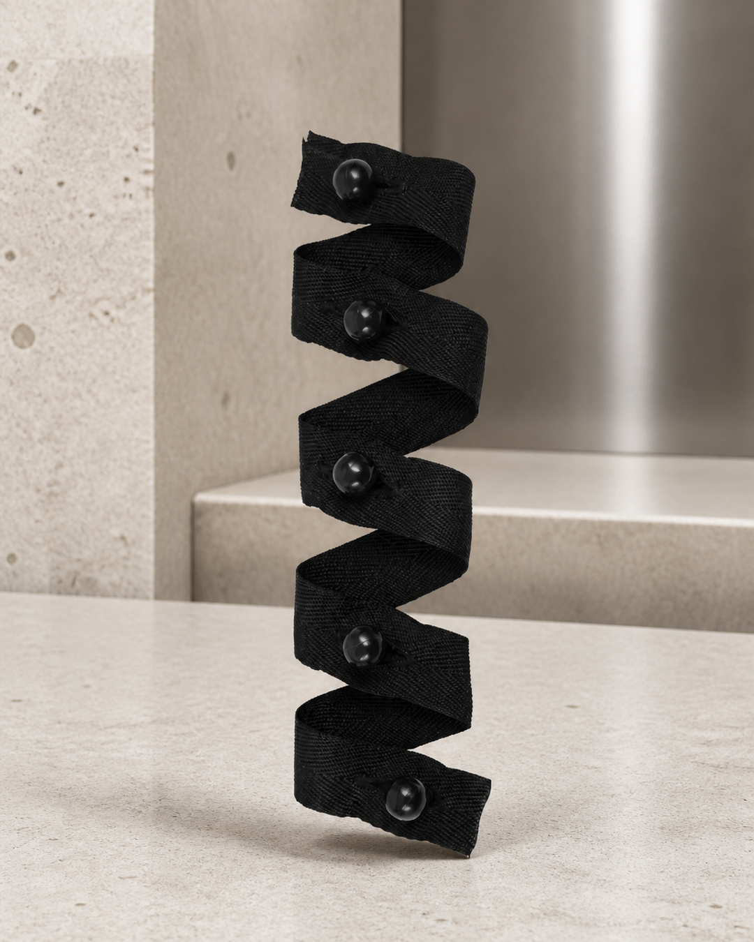 Black stud buttons on tape set with five chef buttons