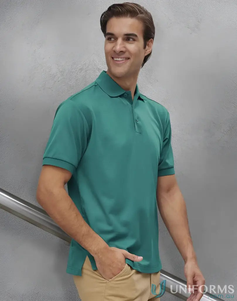 Man in green polo shirt from Sustainable Corporate Polo collection, blocks harmful UV rays
