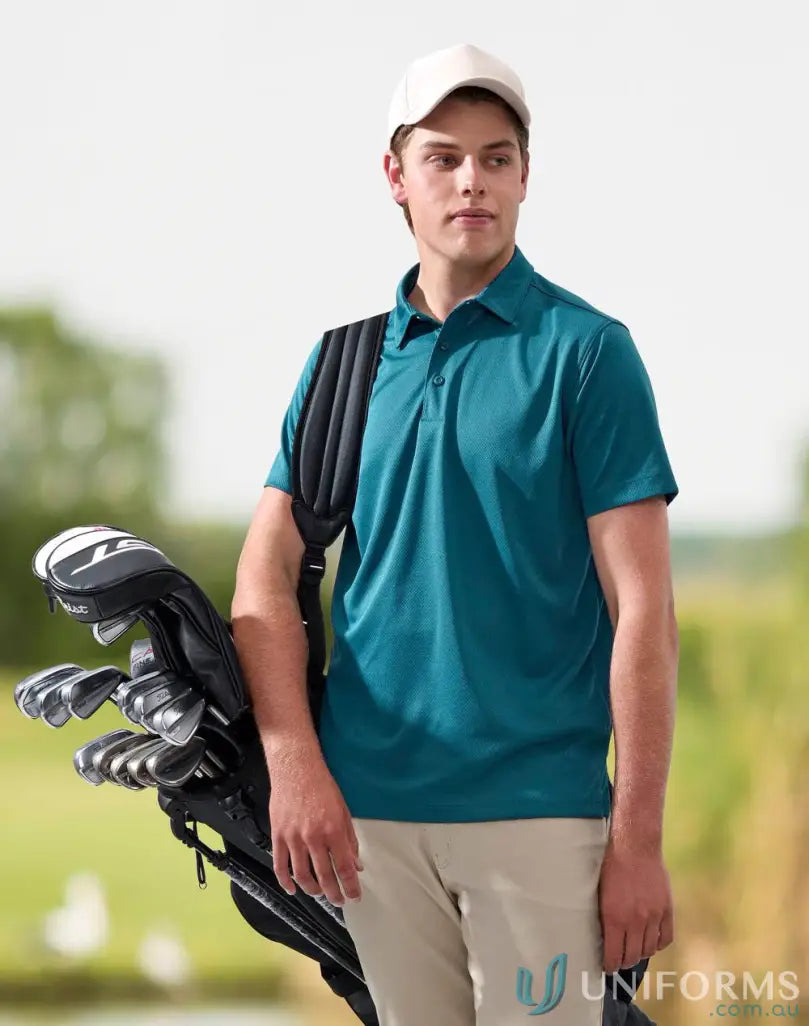 Man in teal polo shirt carrying golf clubs seen in PS95 Sustainable Jacquard Knit Polo