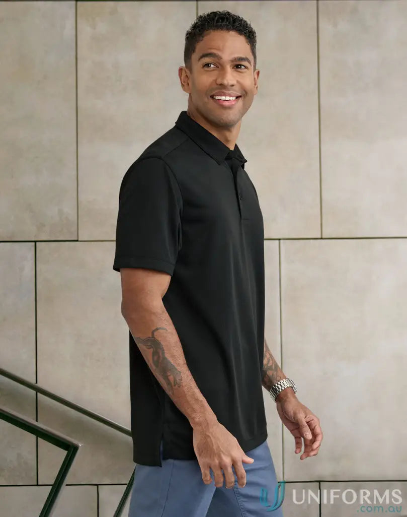 Man wearing black polo shirt from PS95 Sustainable Jacquard Knit Polo line for corporate teams