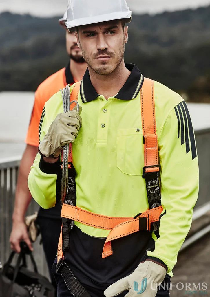 Construction worker in Syzmic Men’s Flux Long Sleeve Polo ZH310 wearing safety gear