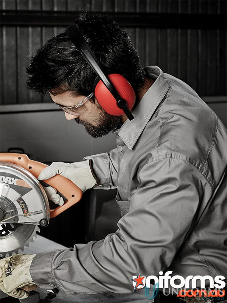 Man in Syzmic men’s lightweight tradie long sleeve cotton twill shirt using circular saw safely