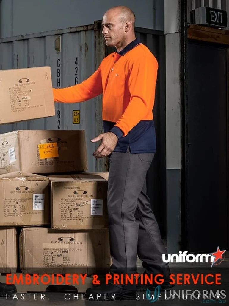 Man in work uniform lifting boxes wearing Syzmic Safety Sliced LS Polo, a vis basic long sleeveâsyzmik unisex style