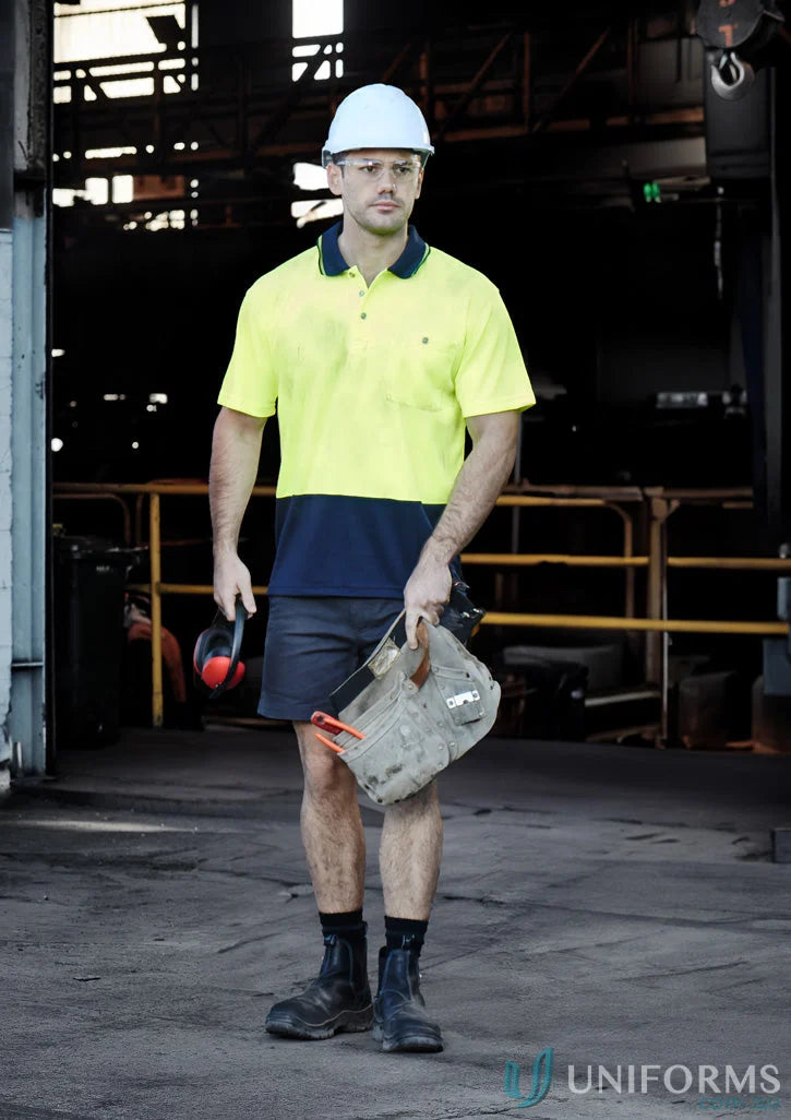 Construction worker in safety gear wearing Syzmic Safety Splice SS Polo, a vis basic short shirt