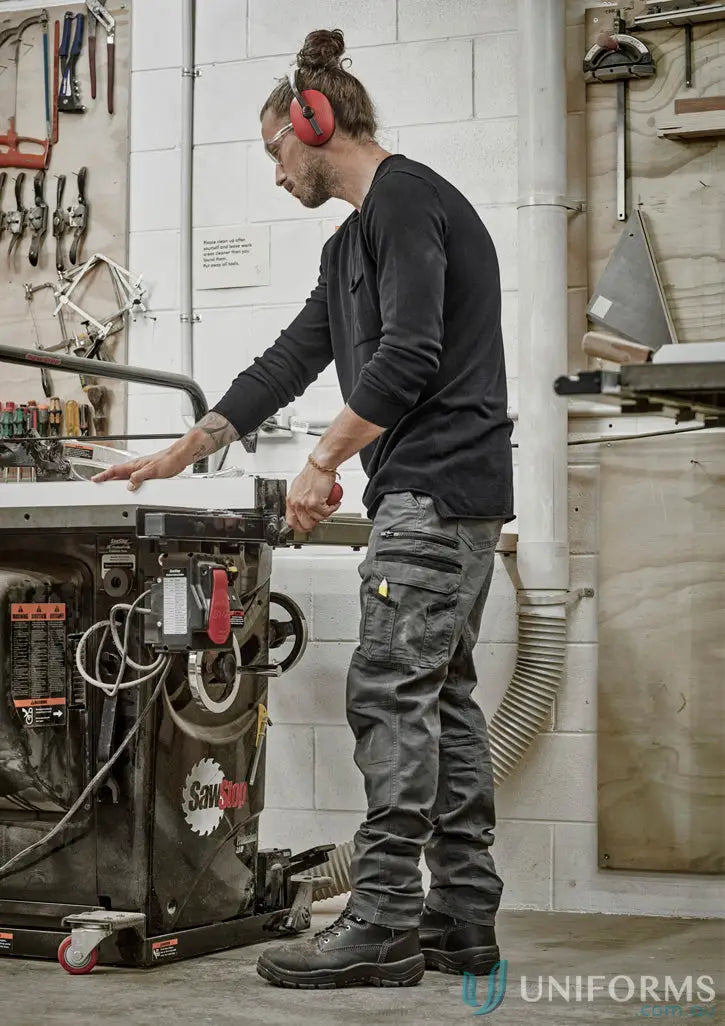 Man in safety gear wearing Syzmic Streetworx Heritage Pant ZP820 operating a table saw