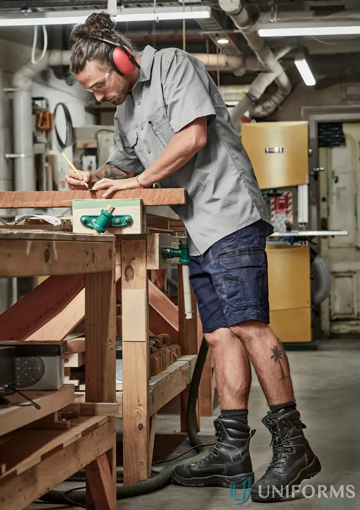 Man in Syzmic Streetworx Heritage Short marking wood with safety gear and mobile phone pocket