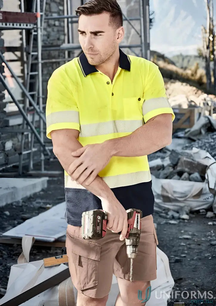 Construction worker holding a drill in Syzmic Unisex Hi Vis Segmented Tape SS Polo