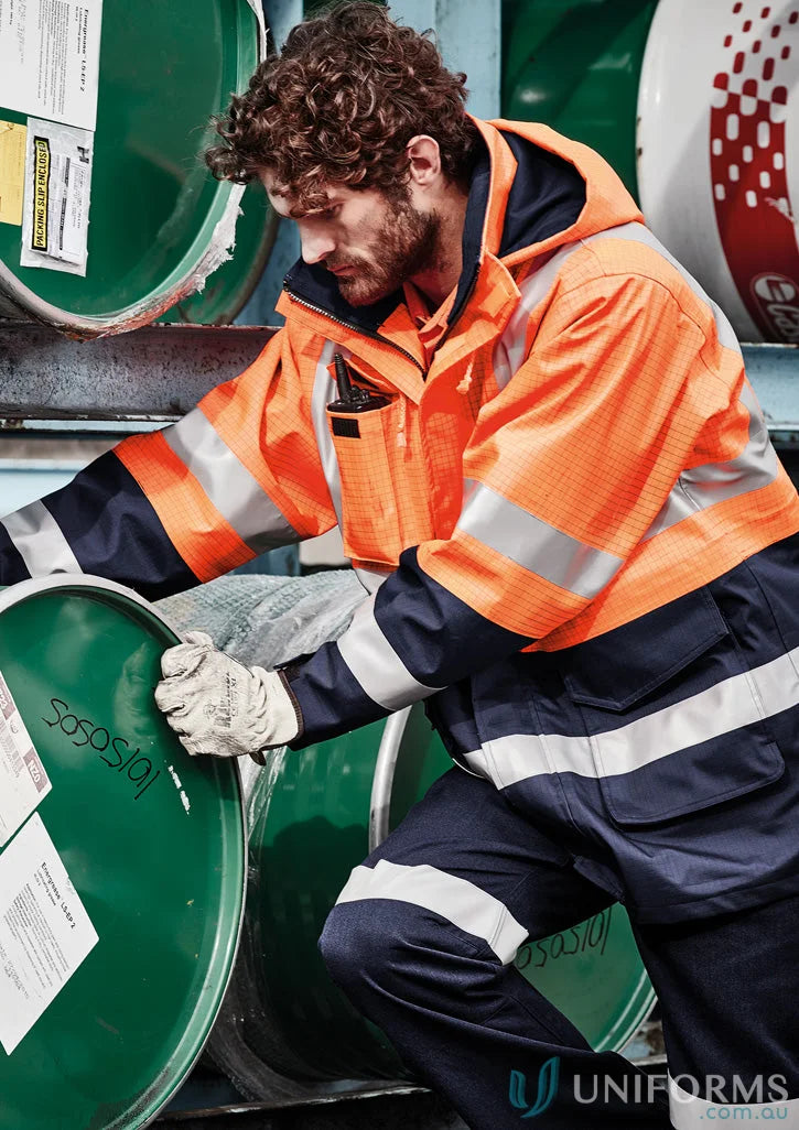 Man wearing Syzmik ZJ900 waterproof jacket, men’s orange flame arc rated antistatic gear