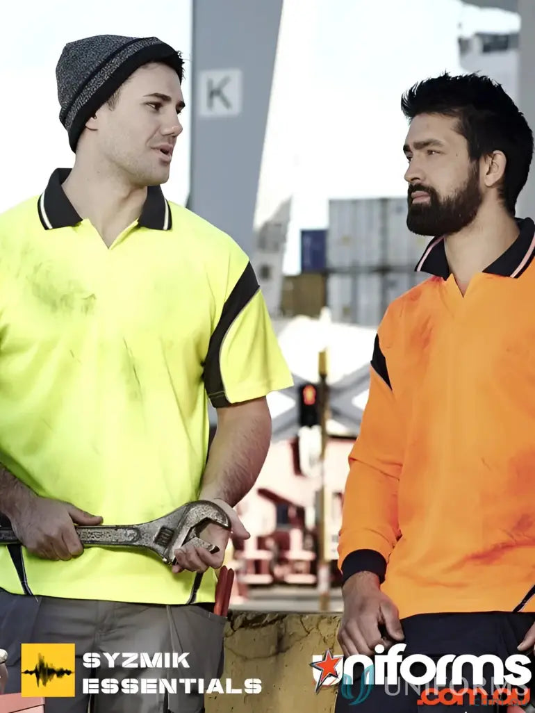 Two men in high-vis Syzmik Men’s Aztec Short Sleeve Polo shirts showing vis aztec style