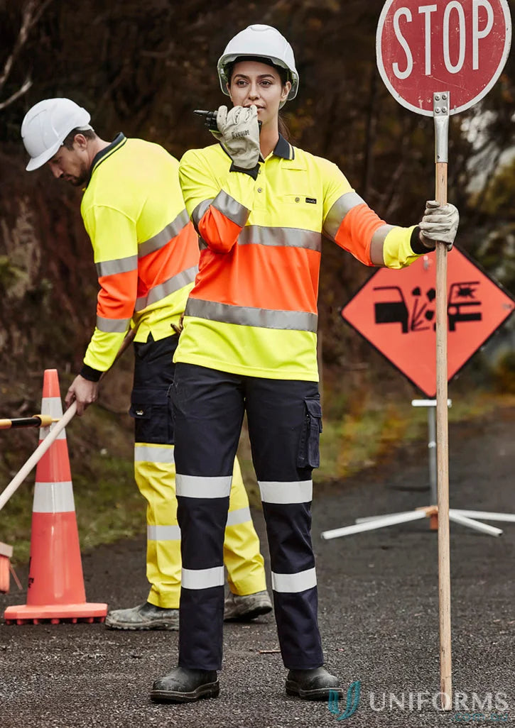 Construction worker holding stop sign wearing Syzmik Ladies BIO Motion Taped Pant ZP720