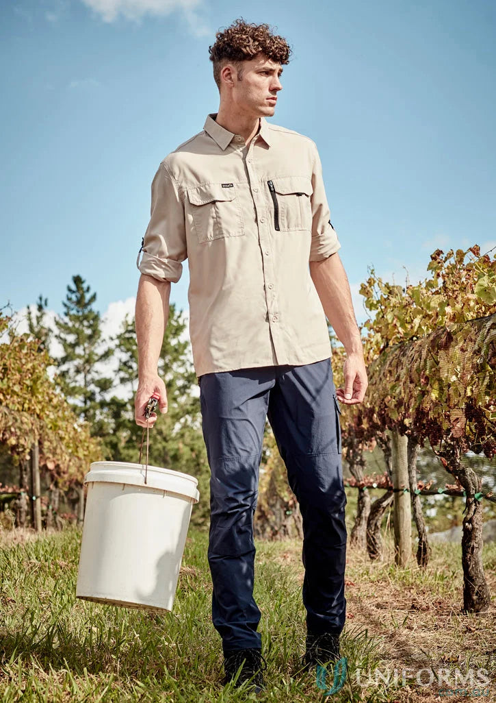 Man in Syzmik Outdoor LS Shirt holding a bucket, ideal for men’s outdoor long adventures