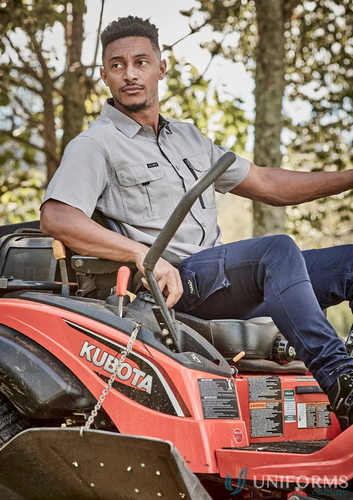 Orange Kubota riding lawnmower with Syzmik Men’s Outdoor SS Shirt ZW465 outdoor short sleeve