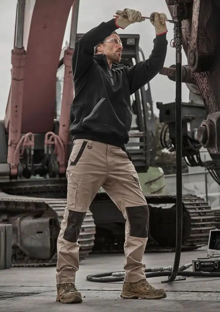 Man wearing Syzmik Unisex Streetworx Water Resistant 1/4 Zip Pullover in Black