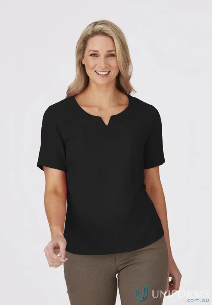 Woman in black top and khaki pants from City Collection Knit woven short sleeve knit collection