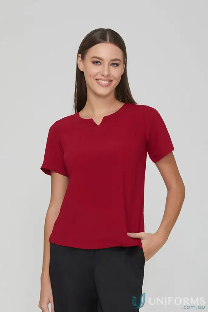 Woman in red top and black pants from City Collection Knit woven short sleeve set