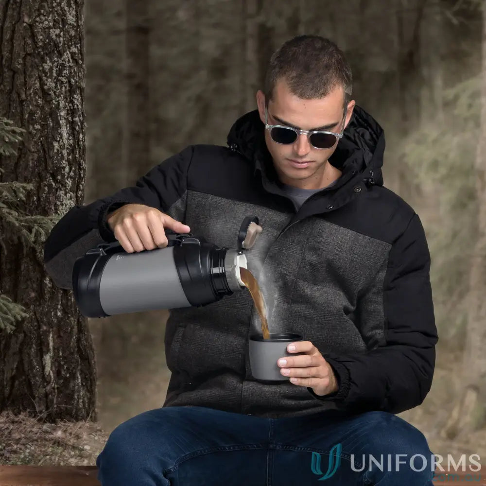 Man pouring hot drink from ToughTank 2L stainless steel vacuum flask with detachable shoulder strap