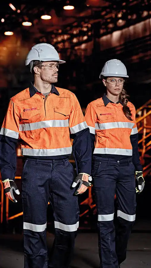 Two construction workers wearing safety gear.