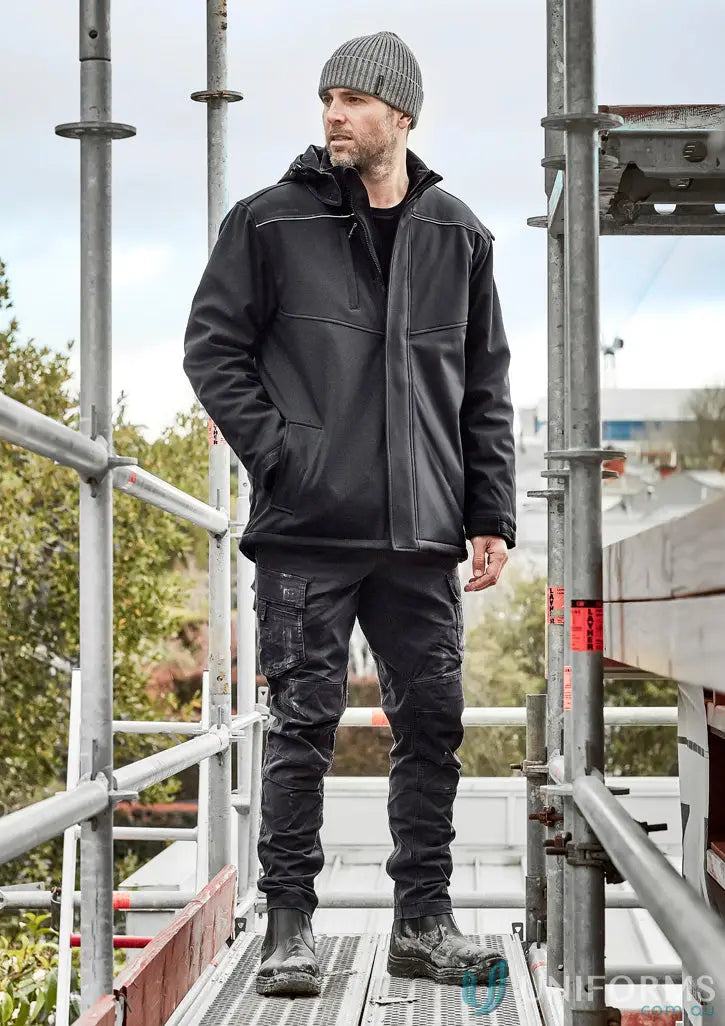 Man in workwear on scaffolding wearing unisex Antarctic Softshell Jacket for tough weather