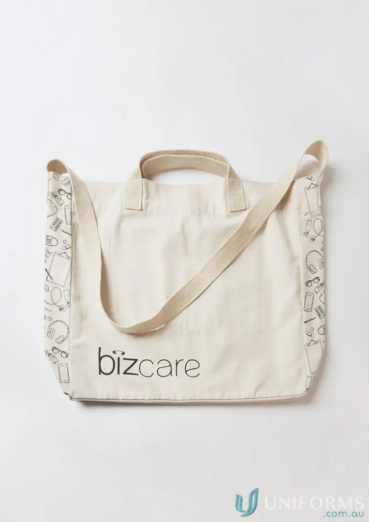 Cream-colored unisex Biz Care Tote Bag with black line art patterns and logo