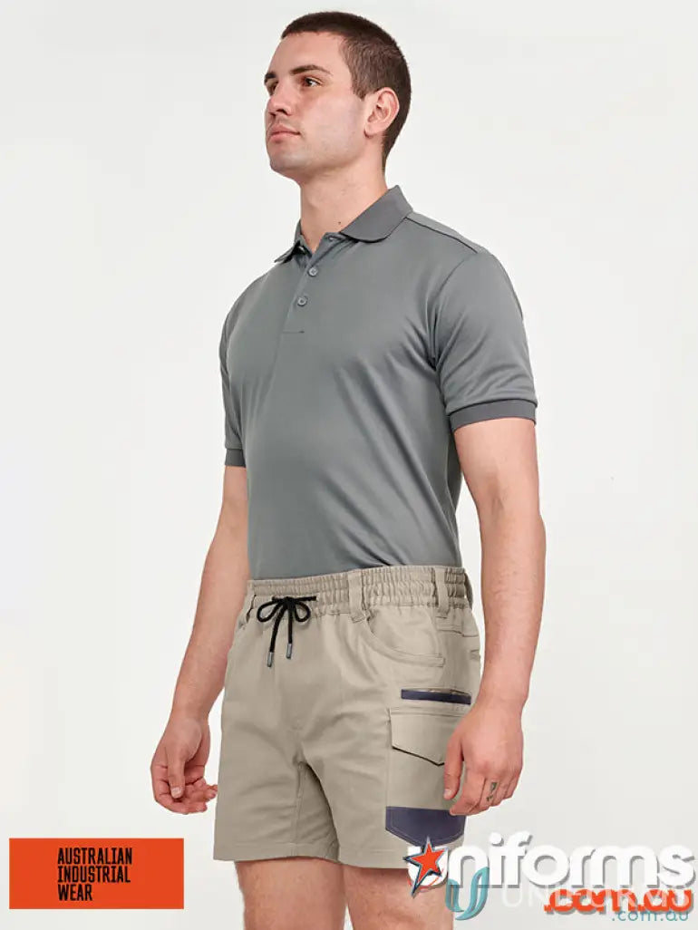 Man in gray polo and khaki shorts showcasing Unisex Cotton Stretch Cuffed Shorts