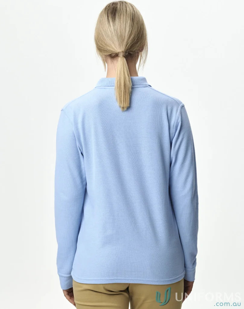 Woman wearing a light blue long sleeve polo shirt in Unisex Pique LS Polo featuring traditional poly cotton